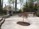 Small plantings in the middle of paver patio